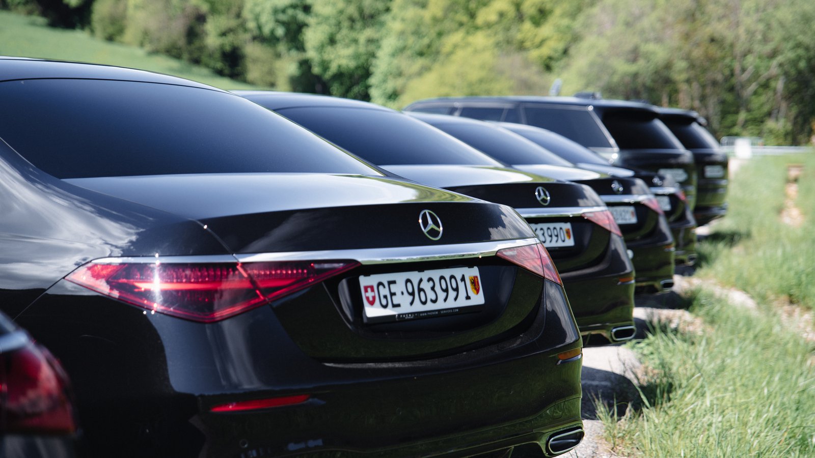A coordinated line of black Mercedes saloons — a Phenom Services delegation convoy